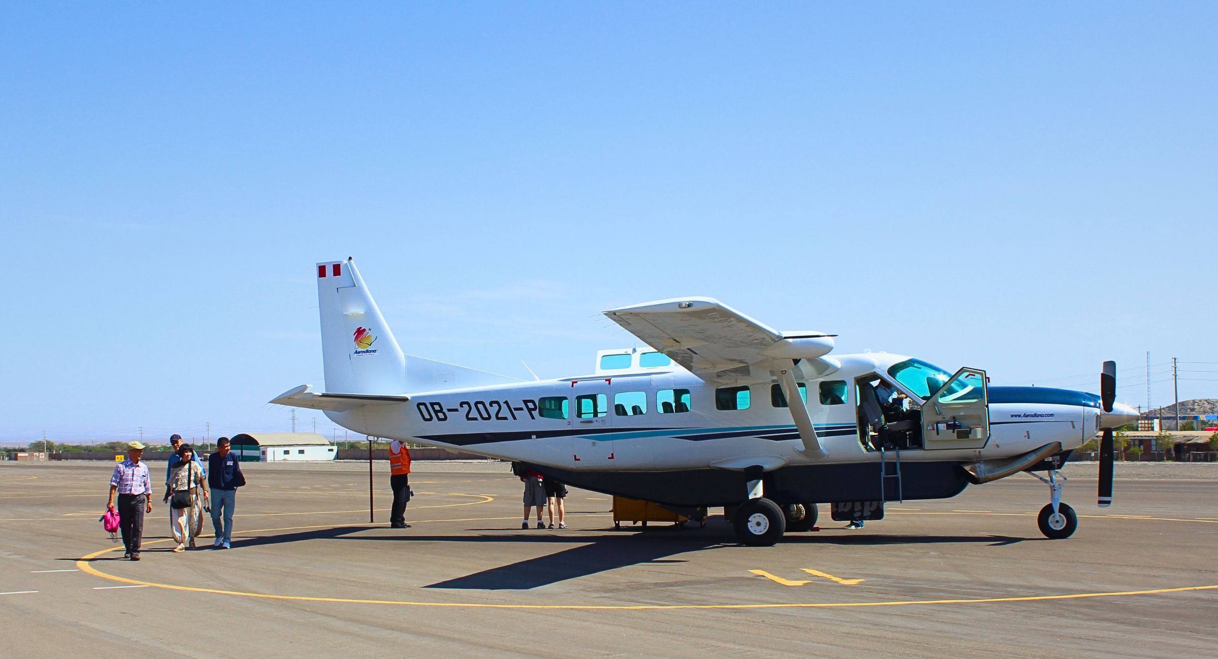 Travelers boarding a Cessna Caravan at the airport for a Nazca Lines flight