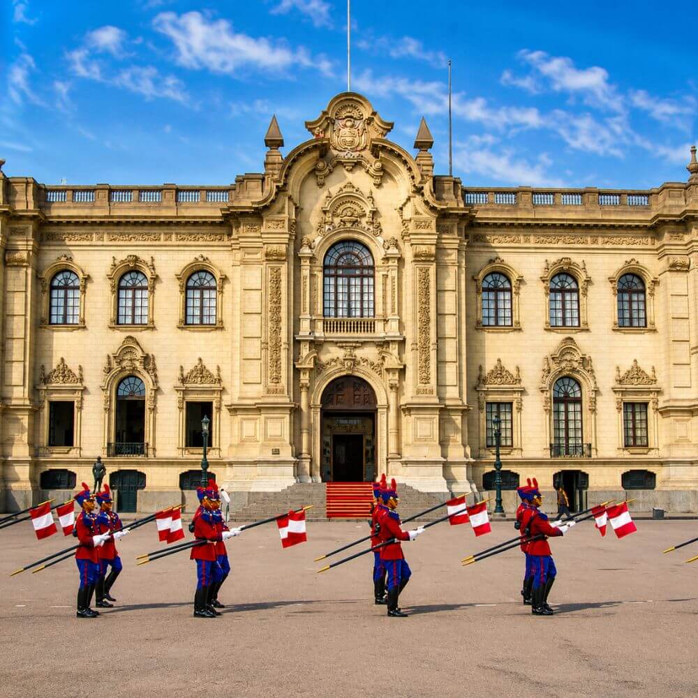 Ceremonial guards marching in front of the Government Palace during the traditional Changing of the Guard in Lima.