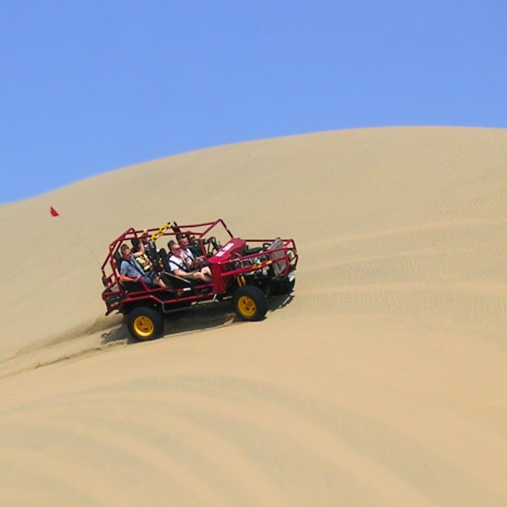 Dune buggy adventure across the giant sand dunes of Huacachina Oasis during a desert tour in Peru