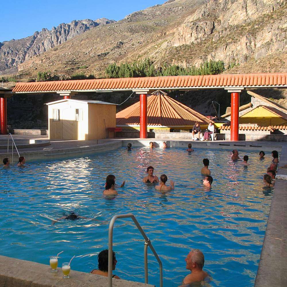 Visitors enjoying the natural thermal pools of Chivay during the Colca Canyon Tour and Trip to Puno.