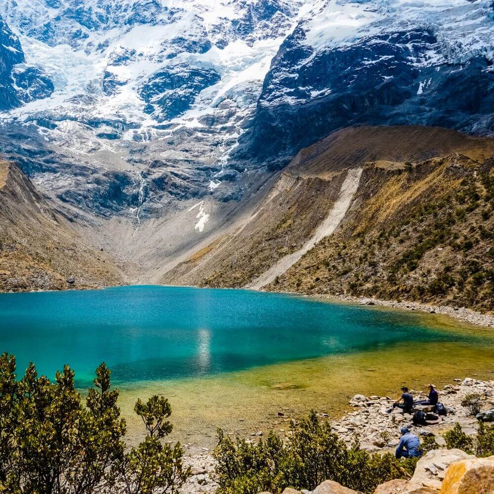 Crystal-clear turquoise waters of Humantay Lake surrounded by the Humantay Glacier in the Peruvian Andes near Cusco.