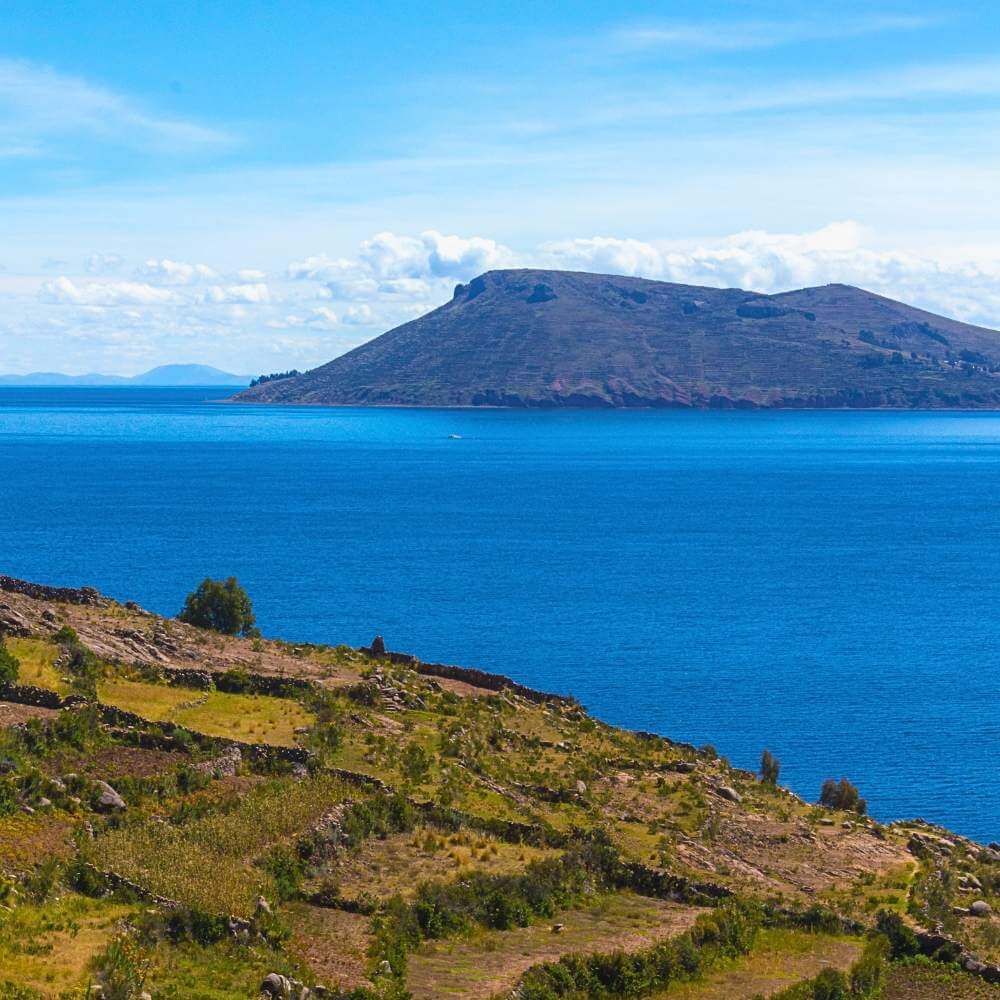Panoramic landscape of Lake Titicaca viewed from Taquile Island during a Lake Titicaca Full Day Tour from Puno.