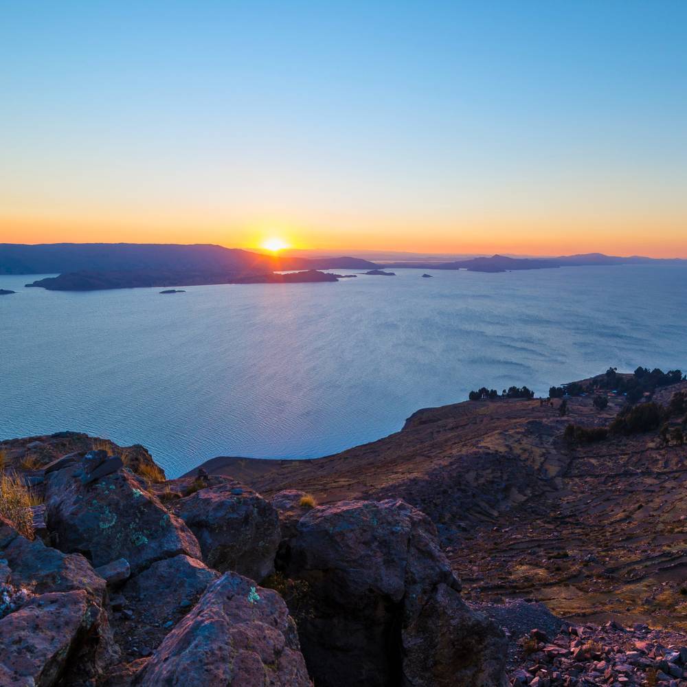 Spectacular sunset over Lake Titicaca viewed from the sacred hilltop of Amantani Island in Peru.