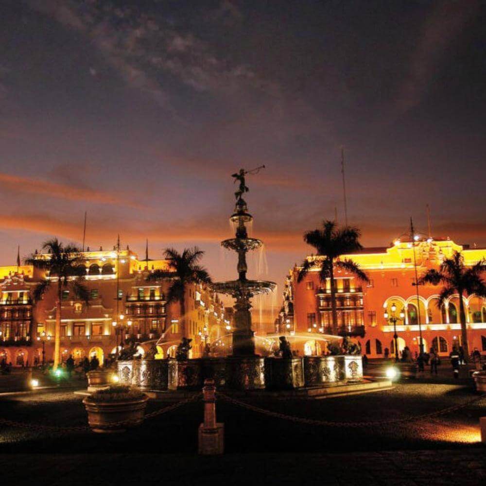 Historic Plaza Mayor illuminated at sunset during a Lima Tour by Night in Lima's colonial center, Peru.