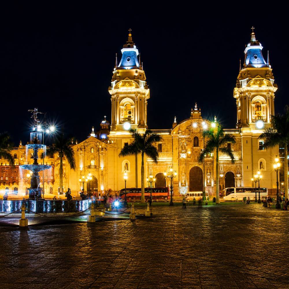 Lima Cathedral glowing under the night sky during a Lima Tour by Night through the historic center of Lima, Peru.