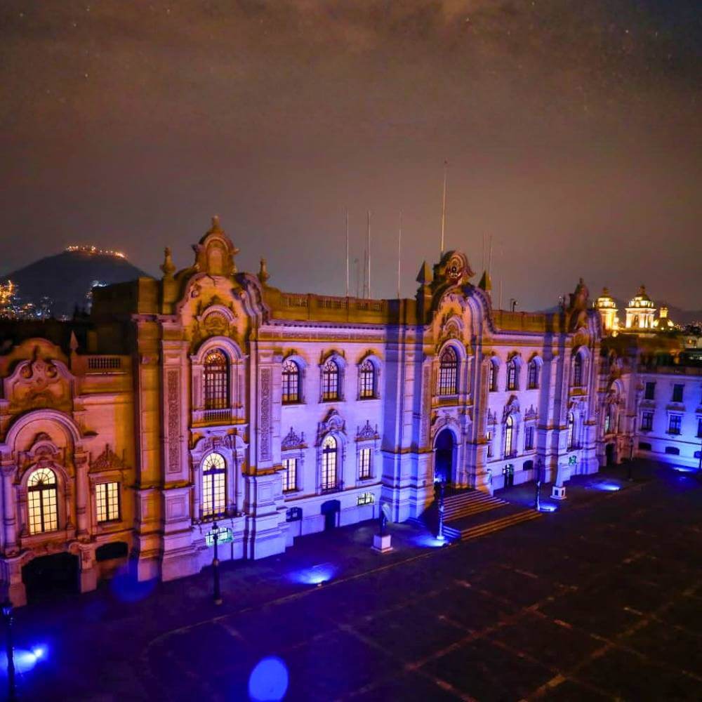 Government Palace illuminated at night in Lima's historic center during a Lima Tour by Night experience.