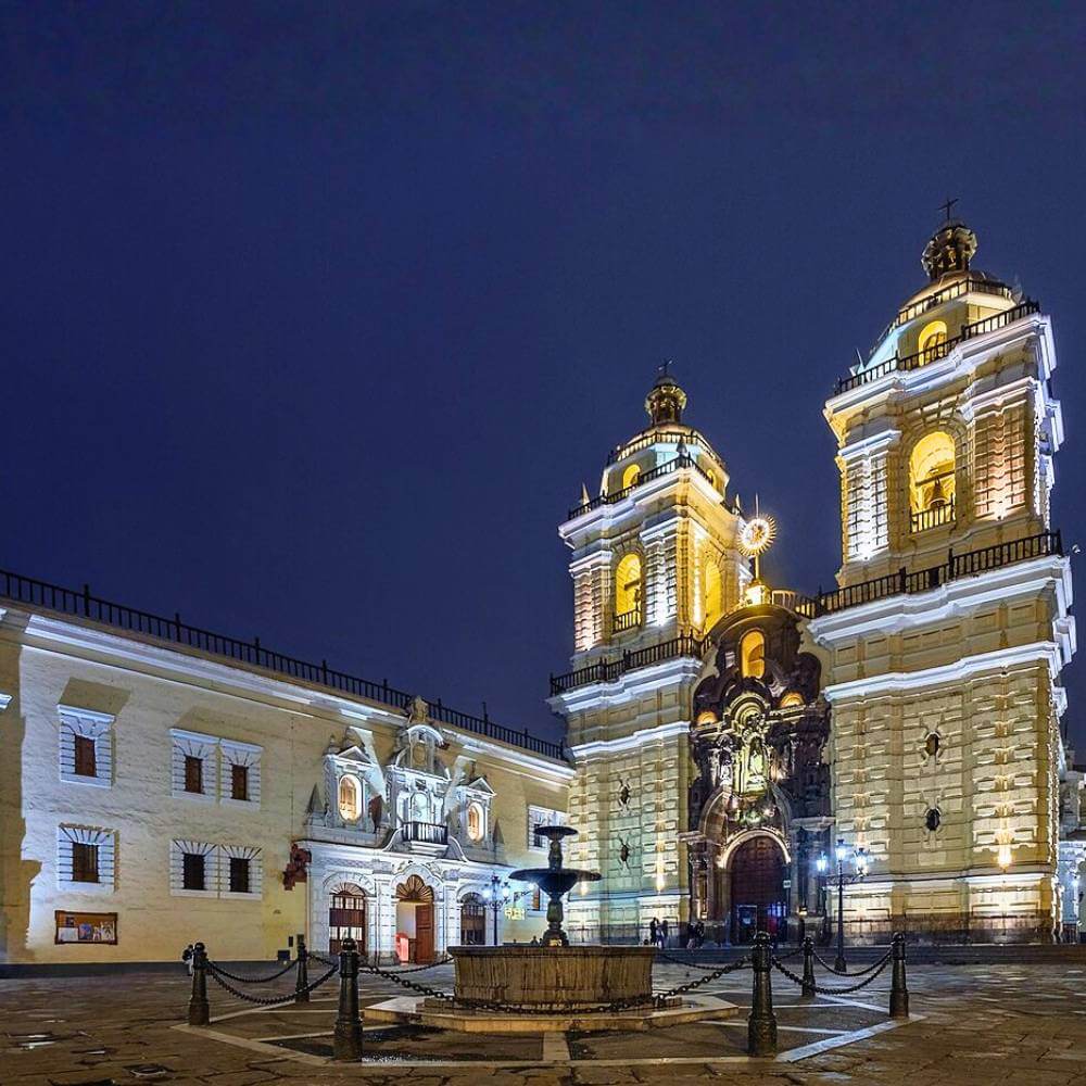 San Francisco Monastery illuminated at night during a Lima Tour by Night in the historic center of Lima.
