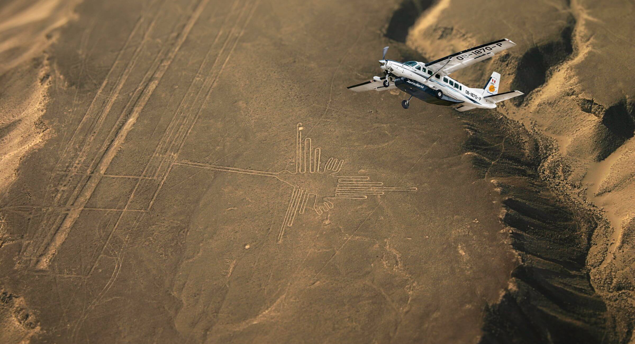 Aircraft flying above the Hummingbird geoglyph in Nazca