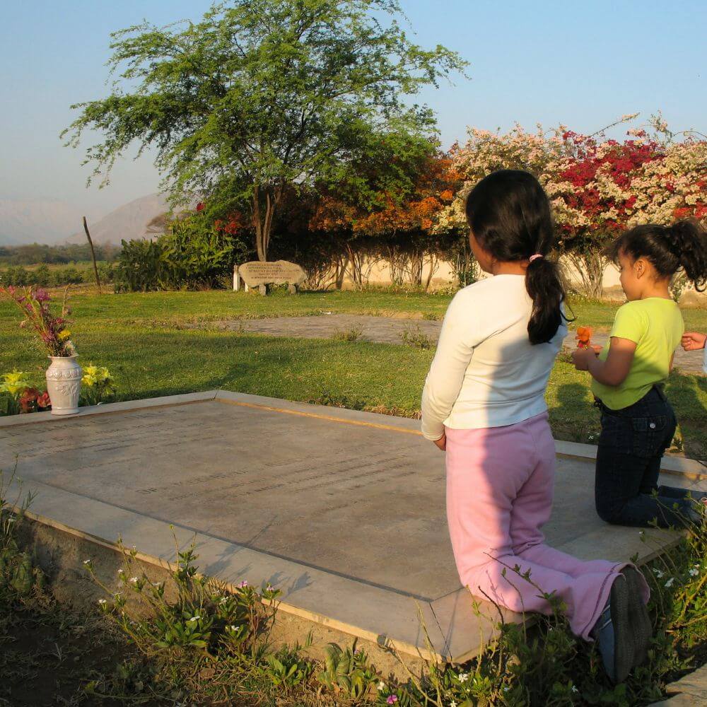 Children visiting the grave of Maria Reiche at the Nazca museum gardens in Peru.