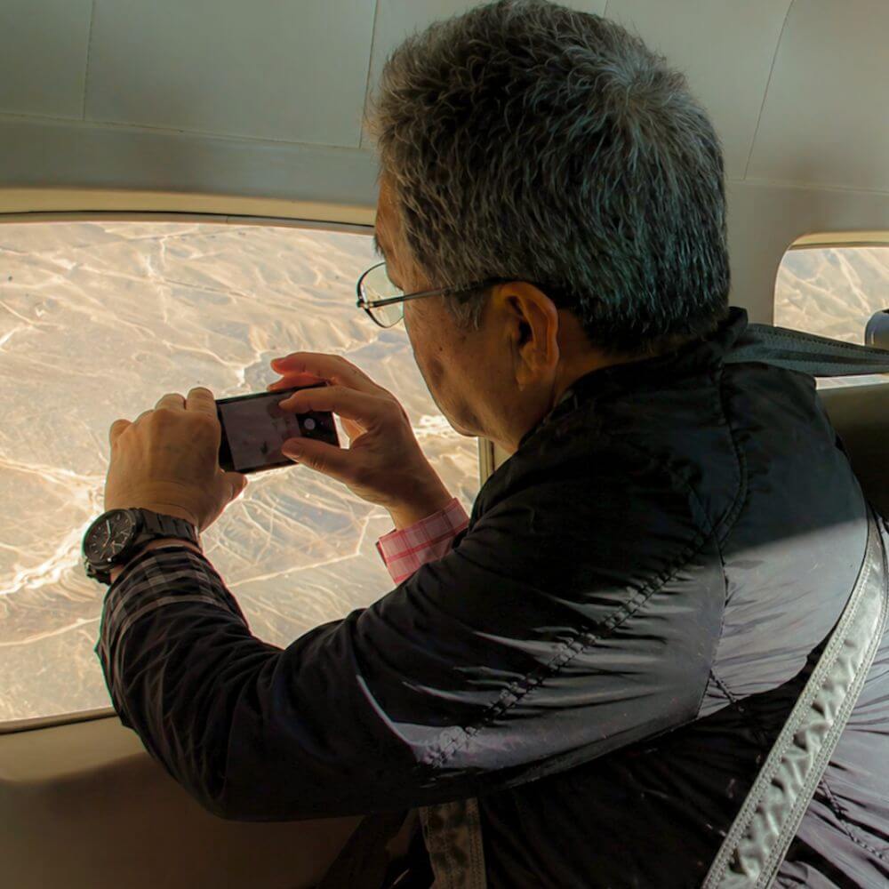 Tourist taking photos during the Nazca Lines scenic flight