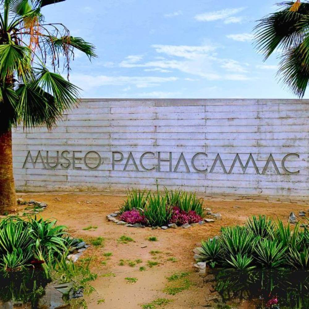 Pachacamac Museum entrance surrounded by desert gardens and native plants near the Pachacamac Archaeological Sanctuary in Lima, Peru.