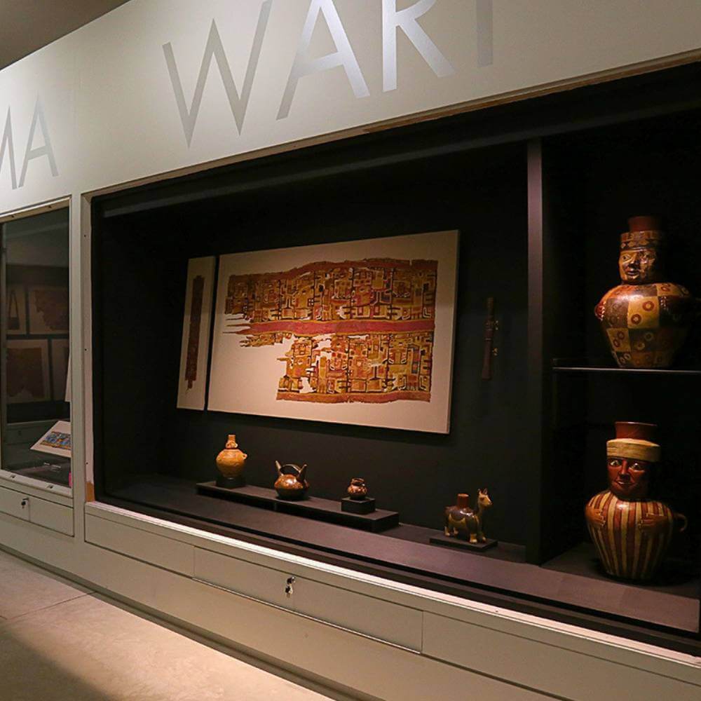 Ancient textiles and ceremonial artifacts displayed inside the Pachacamac Museum near Lima, Peru.