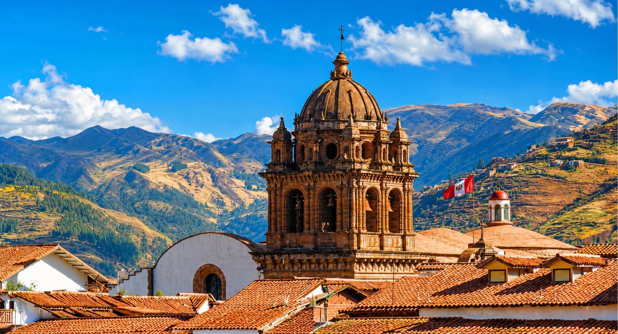 Colonial church bell tower with the Andes in Cusco