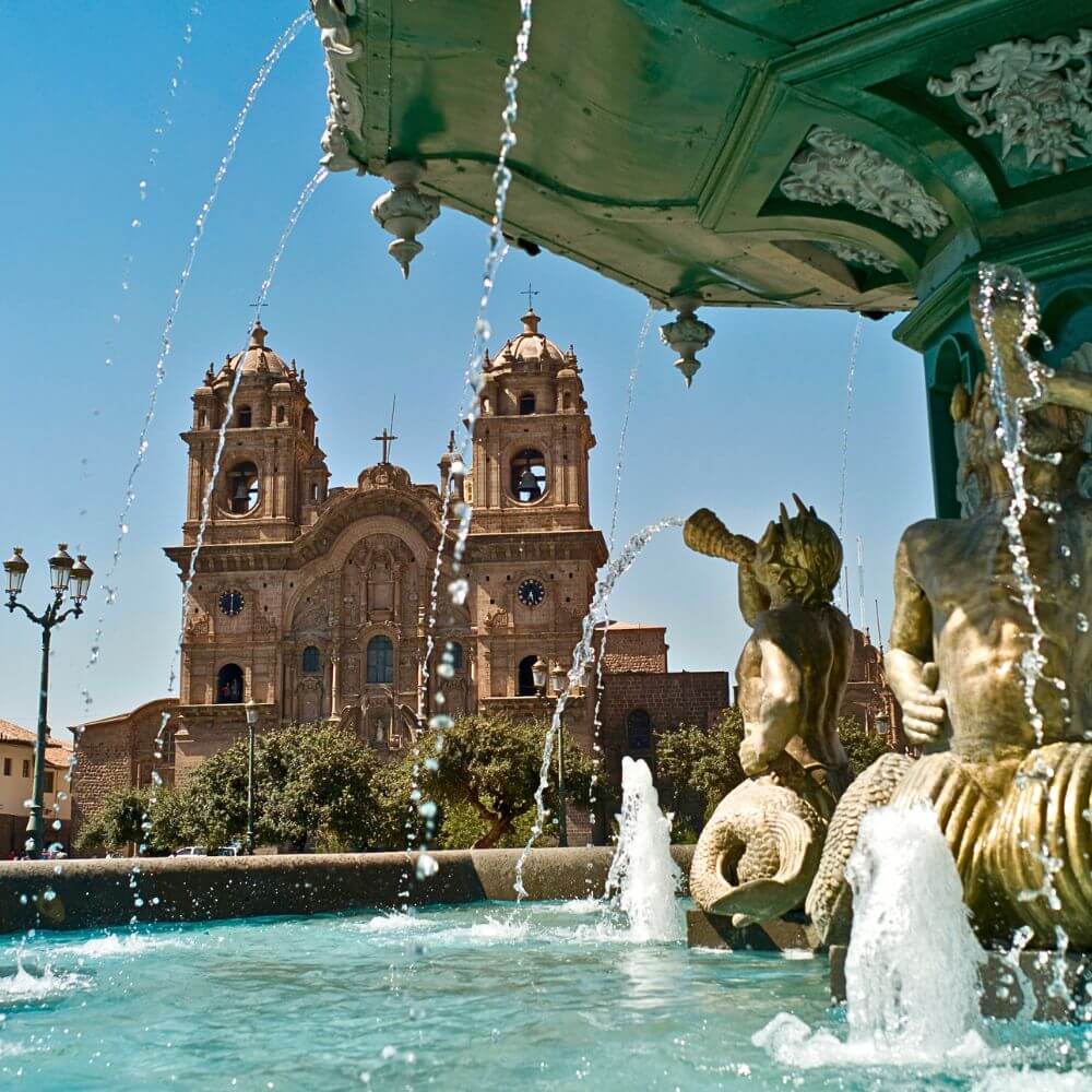 Historic Cusco Cathedral viewed from the fountain in Plaza de Armas, one of the city's most iconic landmarks.
