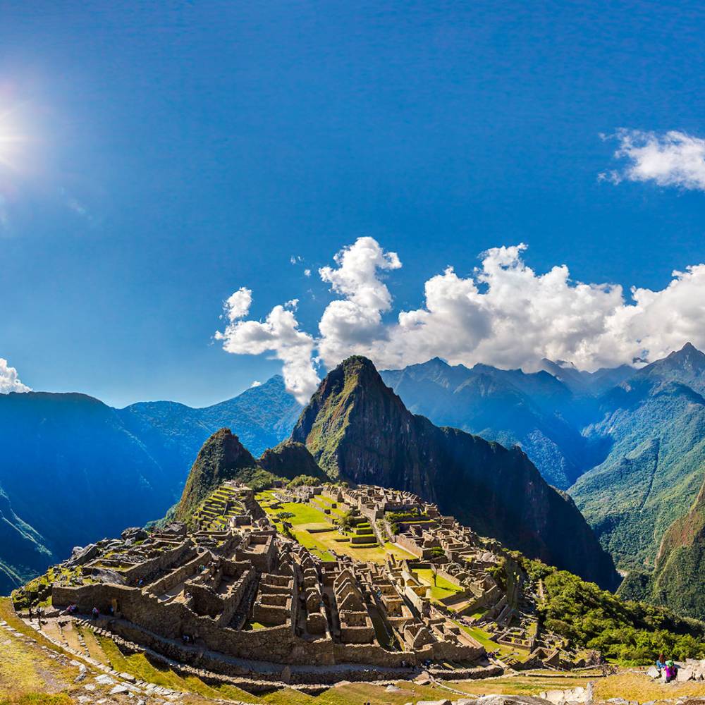 Panoramic view of the ancient Machu Picchu citadel surrounded by the Andes Mountains during a Machu Picchu Full Day Tour.