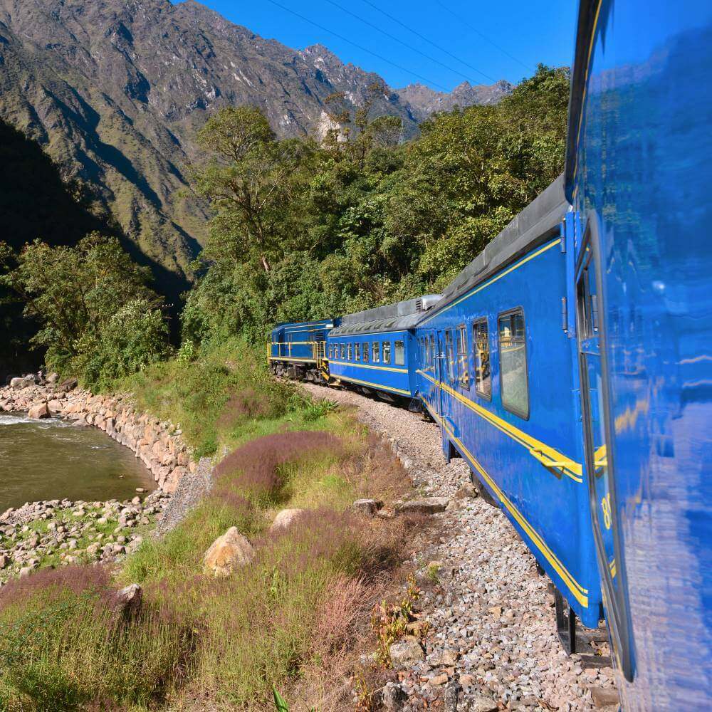 Panoramic Vistadome train traveling through the Sacred Valley on the Machu Picchu Tour by Train from Cusco.