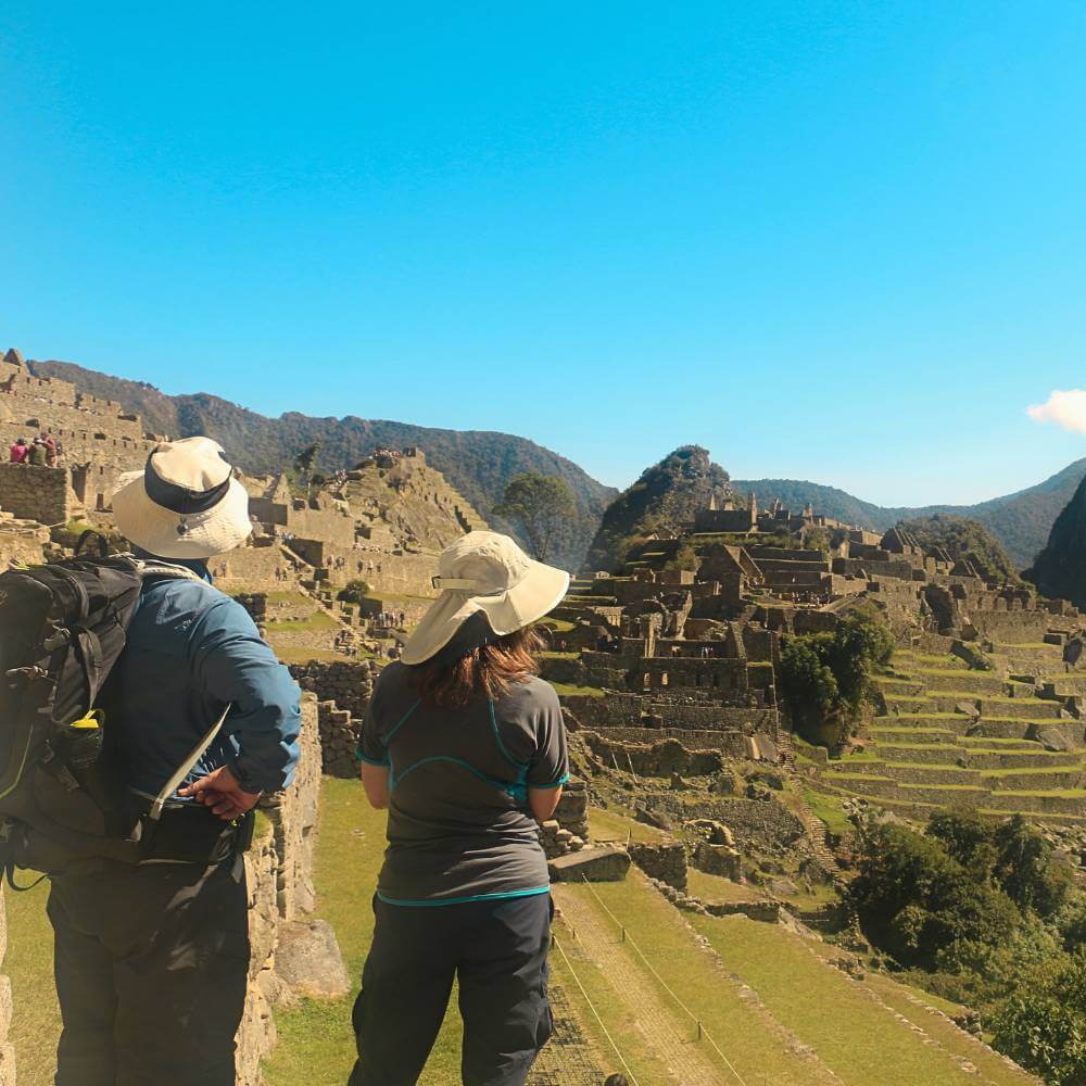 Visitors admiring the panoramic views of Machu Picchu during a relaxing two-day tour from Cusco
