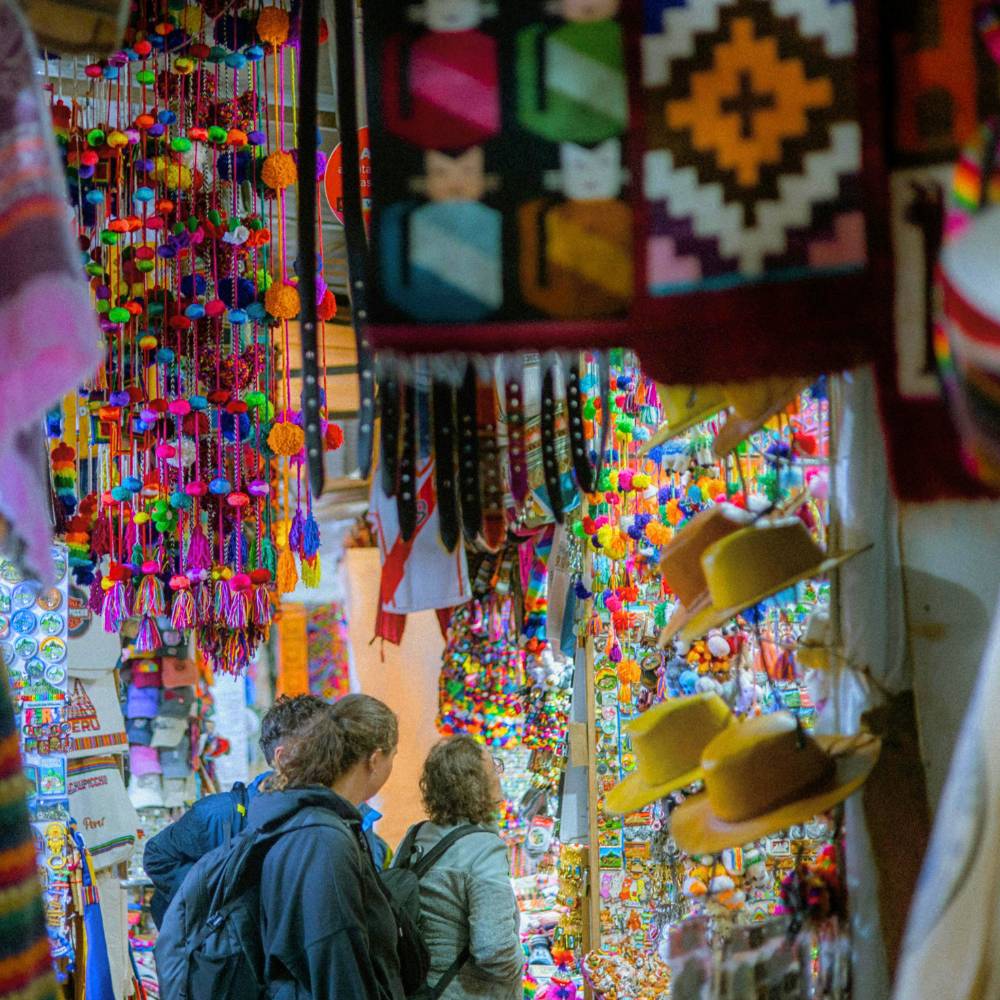 Colorful handicrafts and traditional souvenirs displayed at the famous Pisac Market in the Sacred Valley.