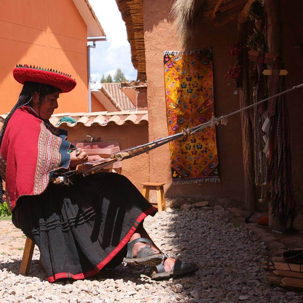 Traditional Andean artisan weaving textiles in Chinchero, one of the most authentic cultural experiences in the Sacred Valley of Peru.