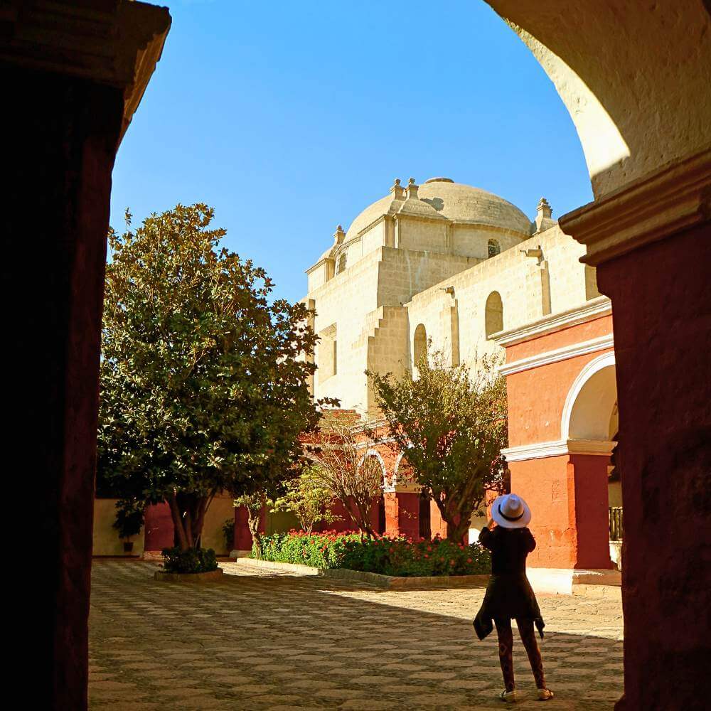 Visitor exploring the peaceful courtyards of Santa Catalina Monastery during a private City Tour of Arequipa, Peru's historic White City.