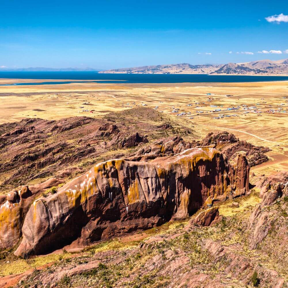 Panoramic view of the sacred Aramu Muru portal overlooking Lake Titicaca near Puno, Peru, featuring dramatic Andean rock formations and breathtaking highland scenery.