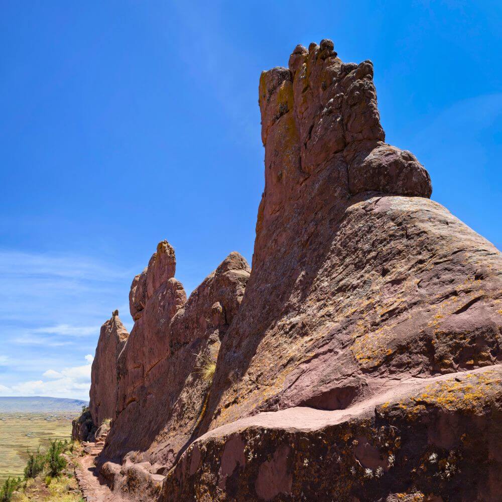 Towering volcanic rock formations along the Aramu Muru archaeological site near Puno, Peru, on the scenic trail leading to the legendary Gate of the Gods.