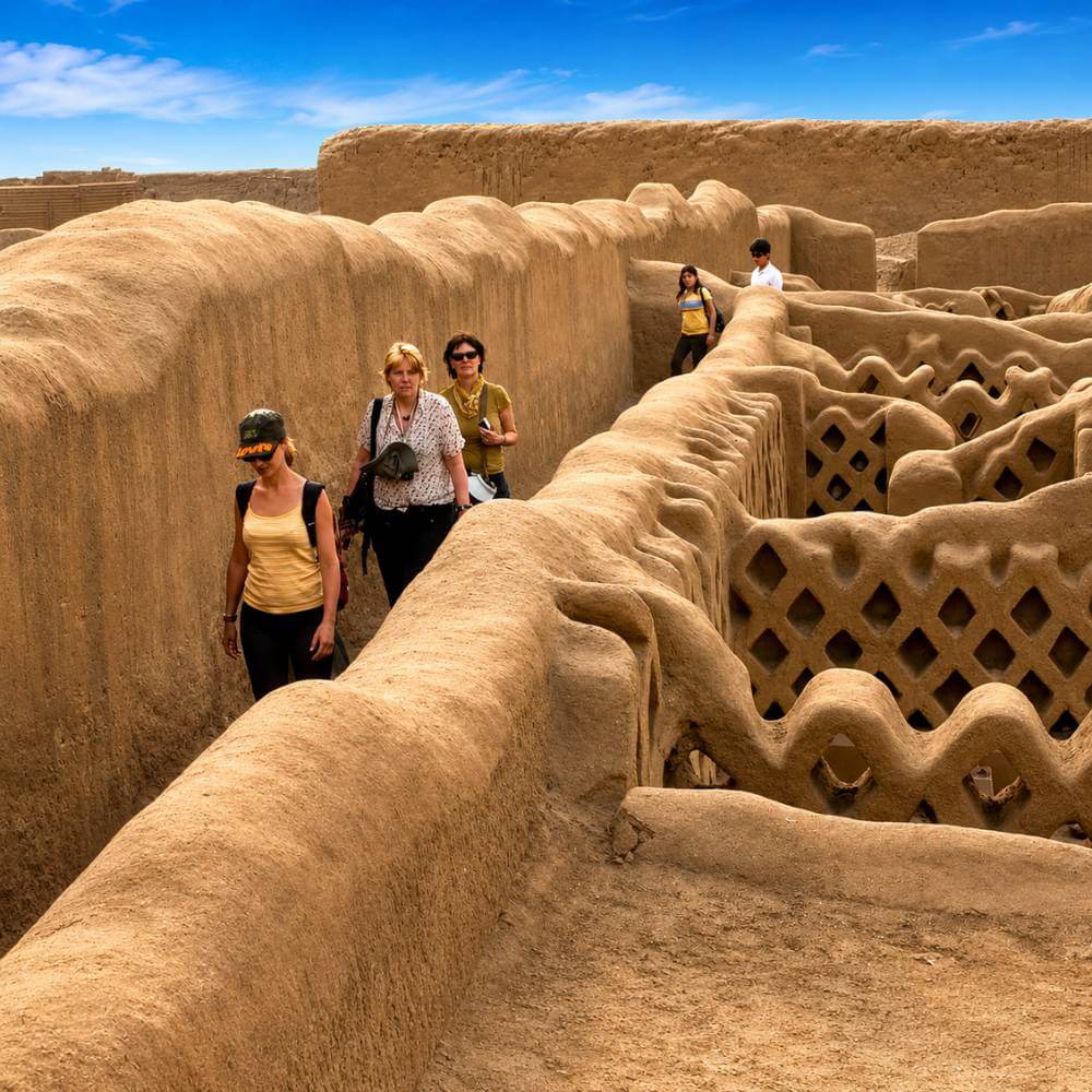 Visitors exploring the ceremonial corridors and royal compounds during a Chan Chan Ruins Tour in Trujillo, Peru