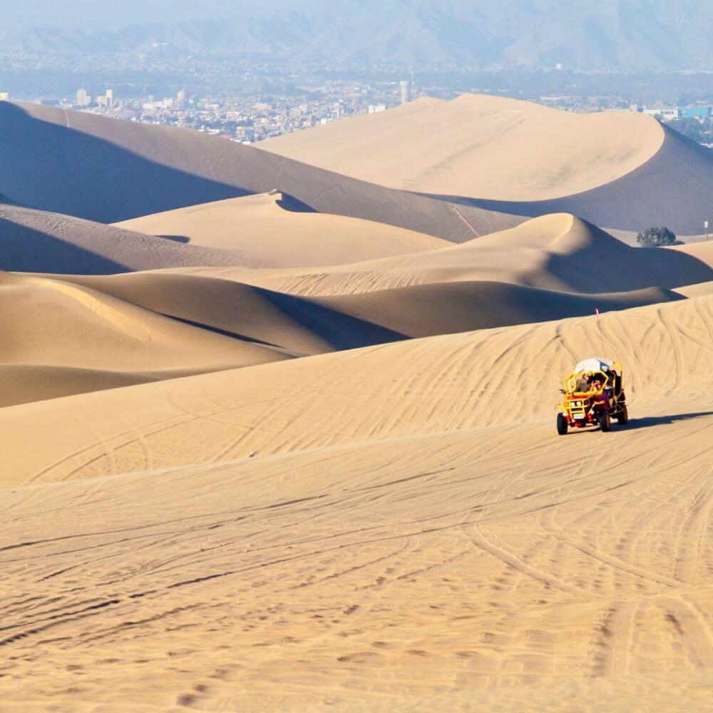 Dune buggy adventure crossing the giant sand dunes of Huacachina Oasis near Ica, Peru.