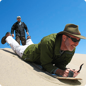 Doing sandboarding in Usaka Desert