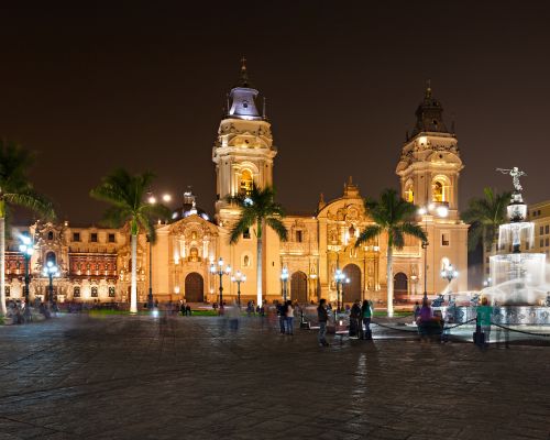 Lima’s Cathedral and Government Palace shining under night lights.