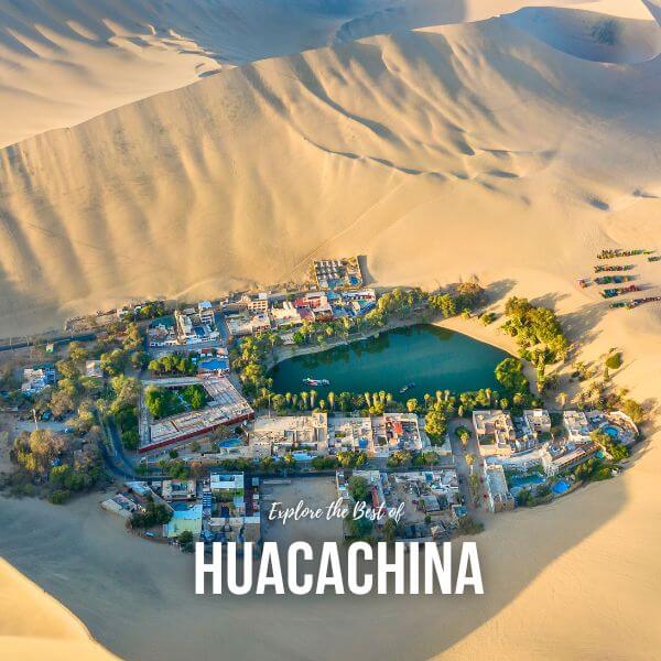 Huacachina Oasis surrounded by palm trees and golden sand dunes.