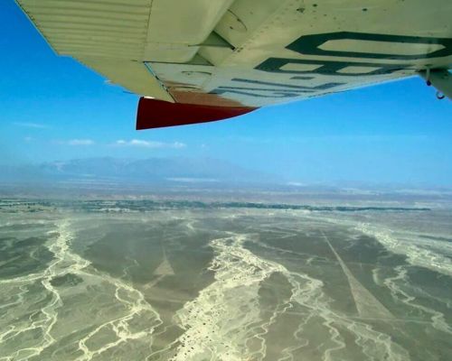 Airplane flying over the Nazca desert