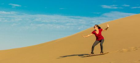 Sandboarding on the dunes near the Moron Oasis.