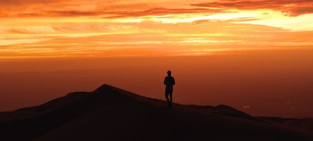 Camper enjoying sunset from Cerro Blanco campsite