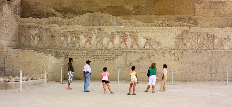 Visitors admiring ancient friezes at El Brujo
