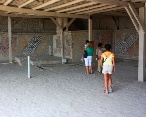 Visitors exploring colorful Moche murals