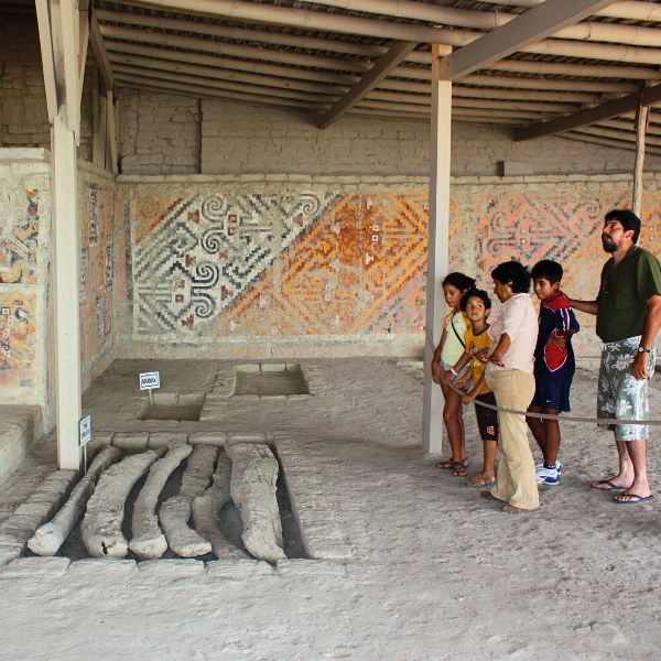 Tour group viewing friezes and tomb of the Lady of Cao.