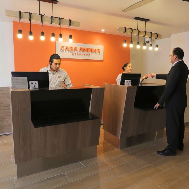 Reception area of Hotel Casa Andina Standard with staff welcoming a guest