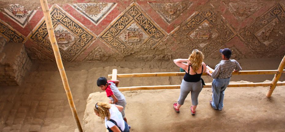 Tourists admiring the ancient murals at the Moon Temple, Moche Valley
