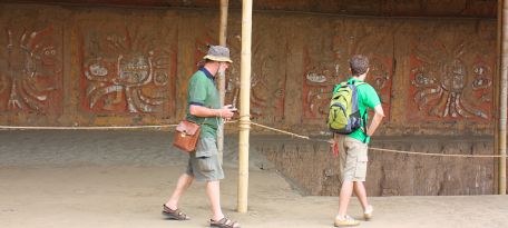 Visitors exploring mural friezes at the Moon Temple of Moche culture