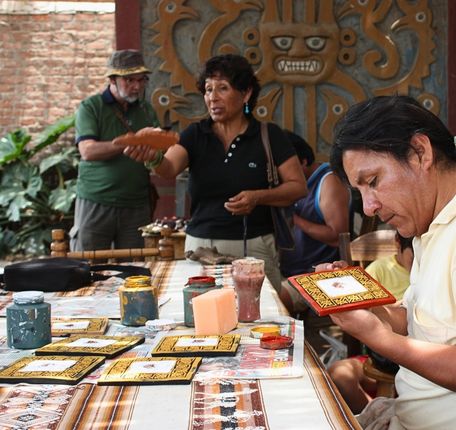 Artisan creating traditional Moche pottery in a local workshop