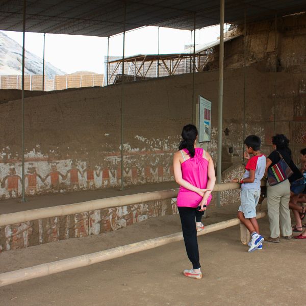 Visitors admiring ancient Moche murals inside the Temple of the Moon